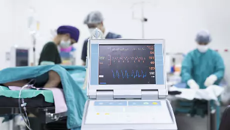 Care team monitoring a patient on an intra-aortic balloon pump in the cardiac intensive care unit