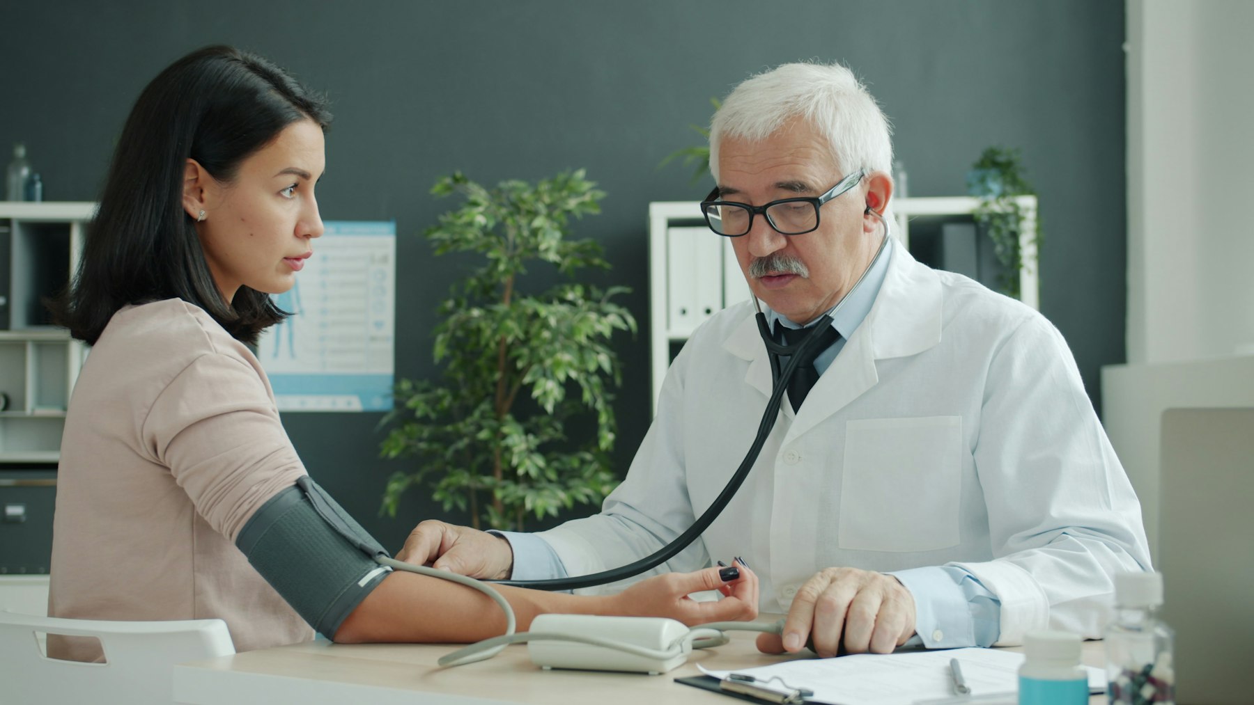 Cardiologist checking a patient’s blood pressure during an AFib treatment visit